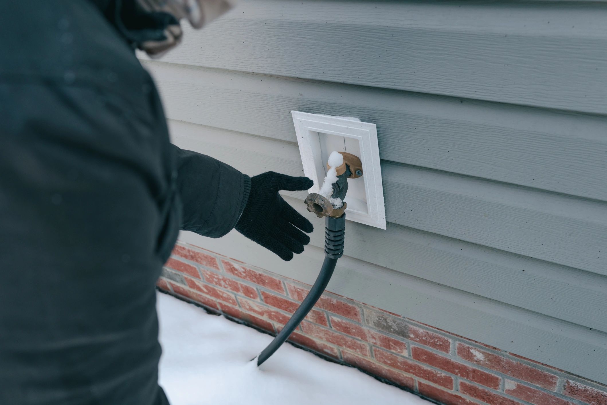 Close inspection of an outdoor water fixture during maintenance