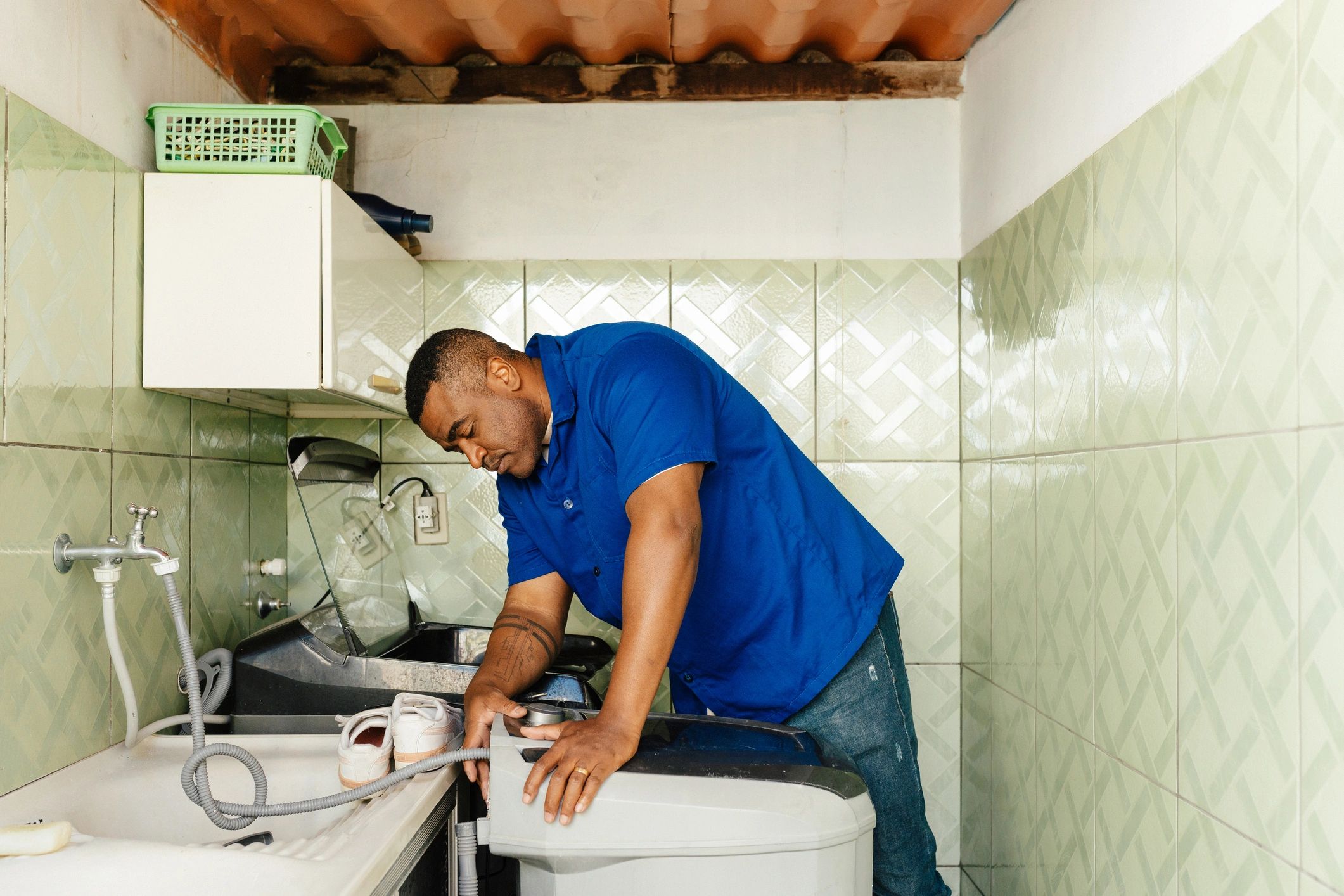 Technician inspecting plumbing-related household equipment